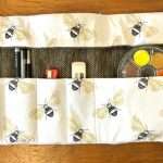 inside of textile art kit decorated with bees. It shows the equipment that is included